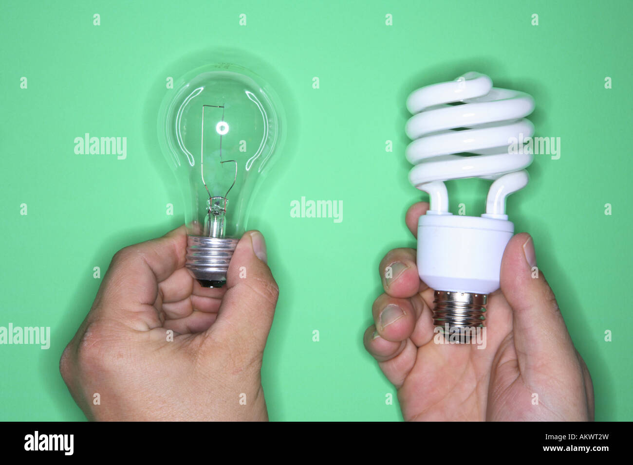 Hands holding traditional and energy efficient lightbulbs Stock Photo
