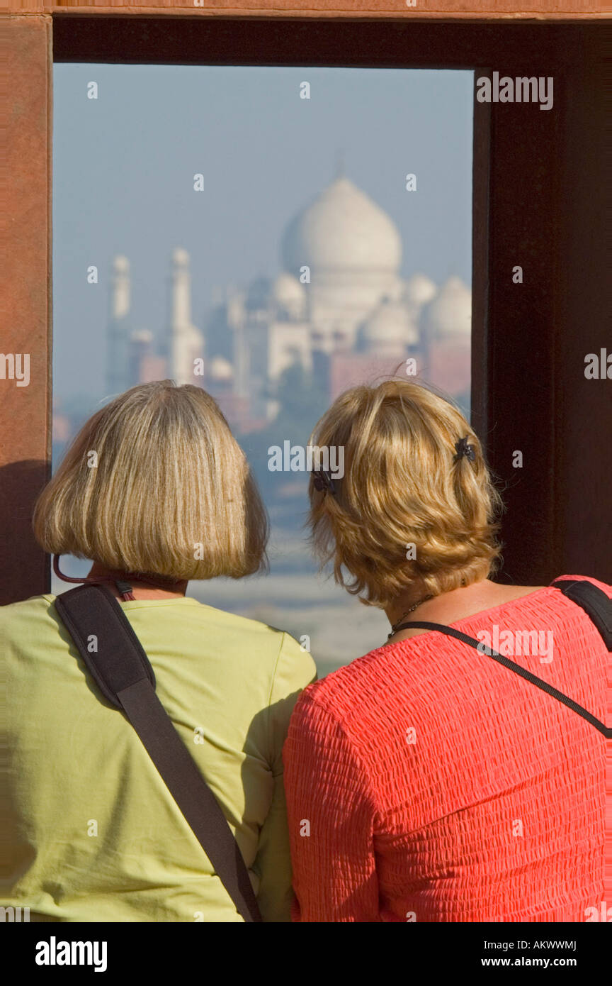 Lynne Valentine and Alice Norton gaze at the Taj Mahal from Agra's Red Fort in Agra, Uttar Pradesh, India. - Stock Image
