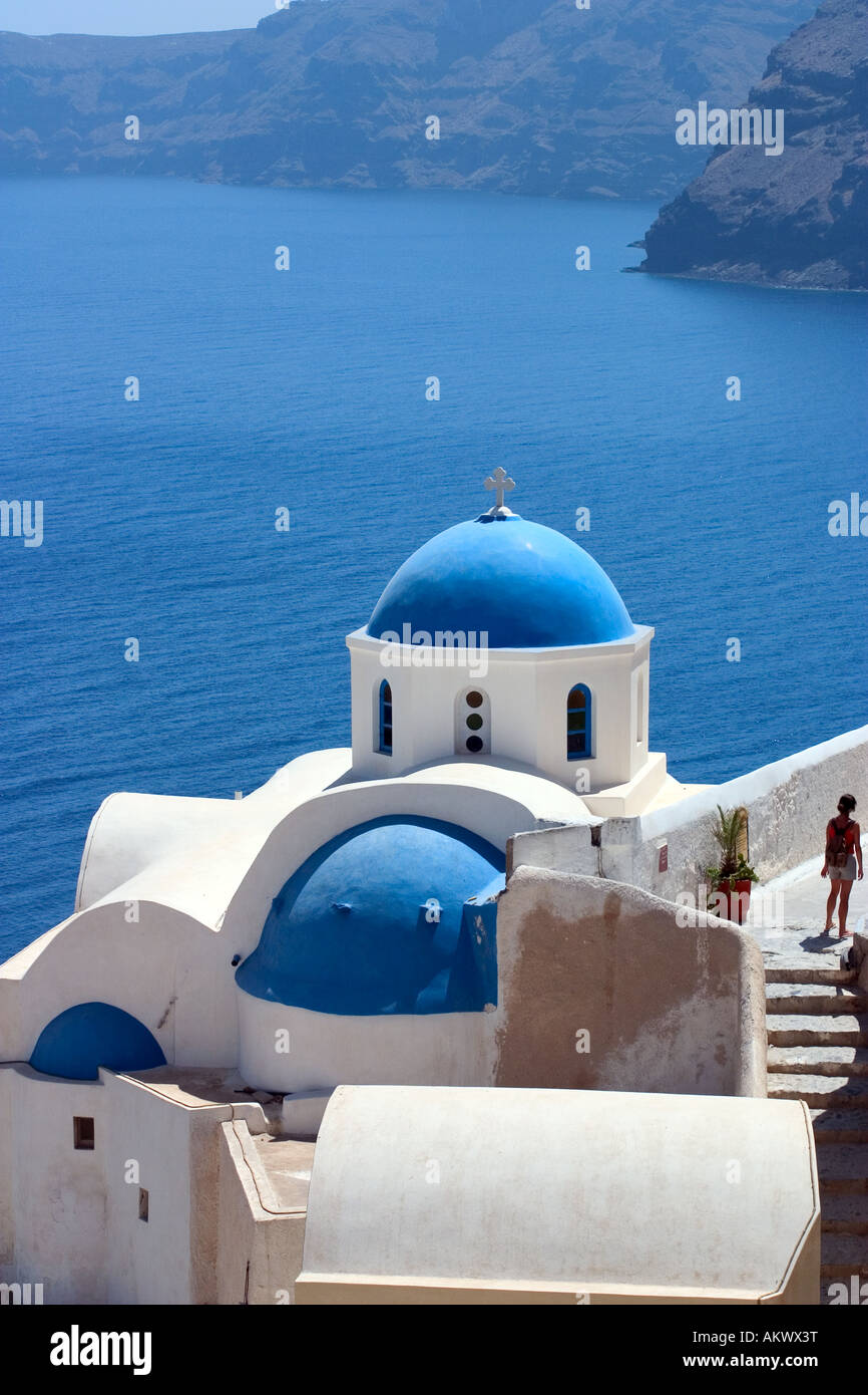 View of one of the famous churches in Oia or Ia on Santorini looking out across the volcanic caldera or lagoon Stock Photo