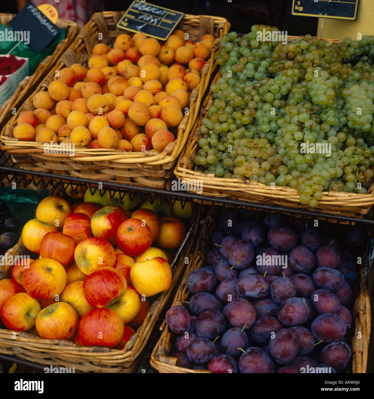 Colourful display of an abundance of fruits in wicker baskets on market stall in South of France