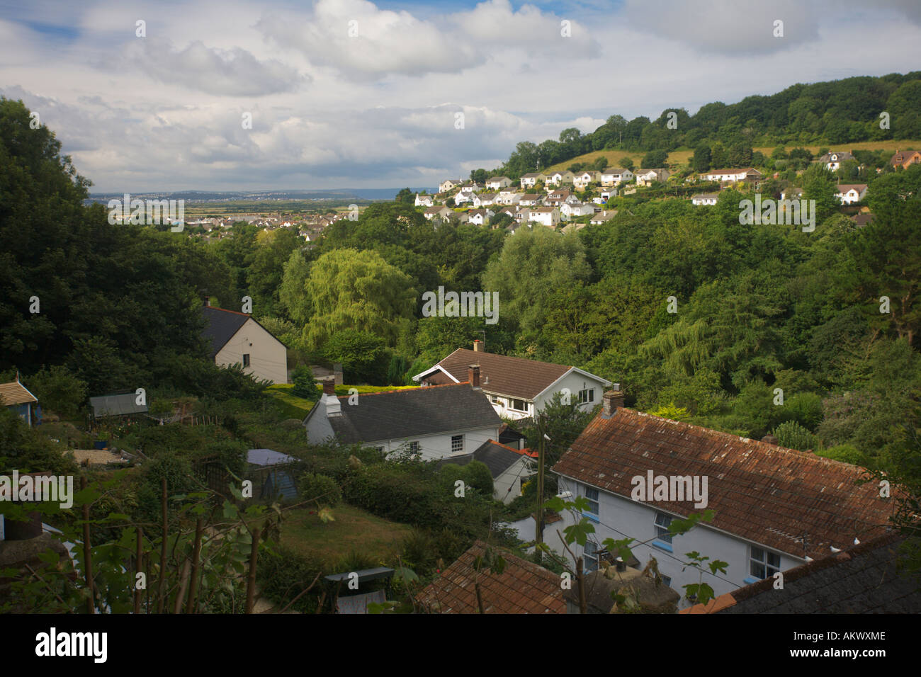 View south over rooftops of houses and gardens in Braunton to Taw Estuary and Westward Ho! in distance Devon England Stock Photo