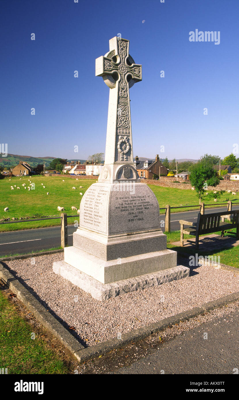 War memorial beside the A76 with the small village of Closeburn behind busy road Nithsdale Scotland UK Stock Photo