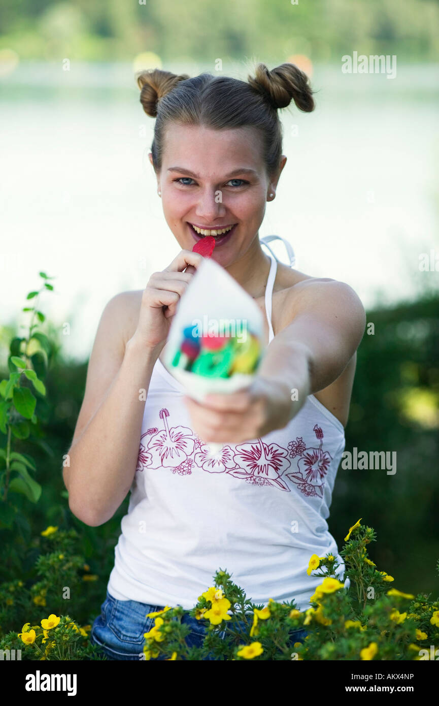 Woman (2025) eating wine gums, closeup Stock Photo Alamy