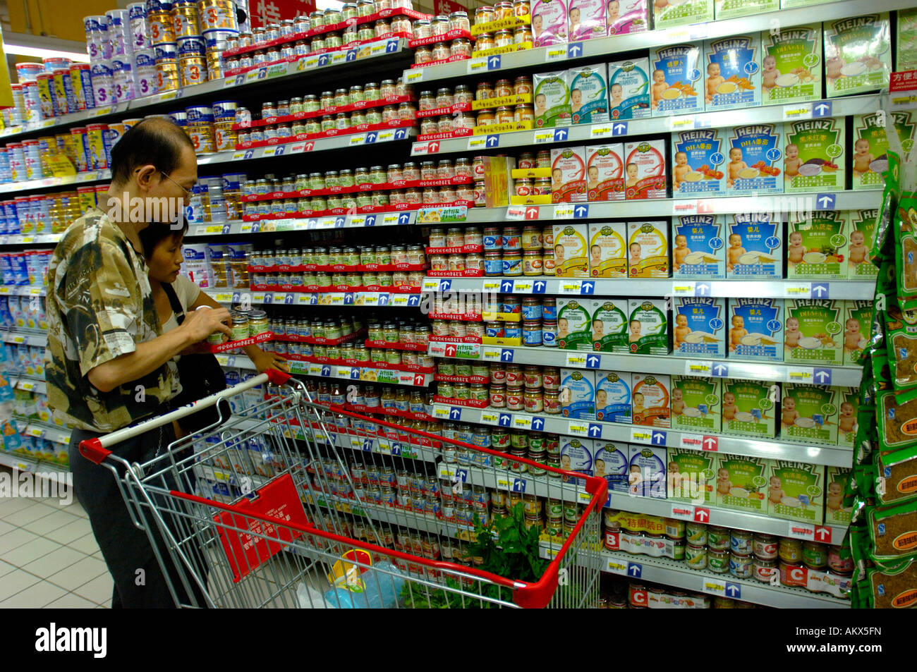 Consumers pick out and buy products at Heinz and Nestle shelves in a Carrefour supermarket in Beijing China 22 Jul 2006 Stock Photo