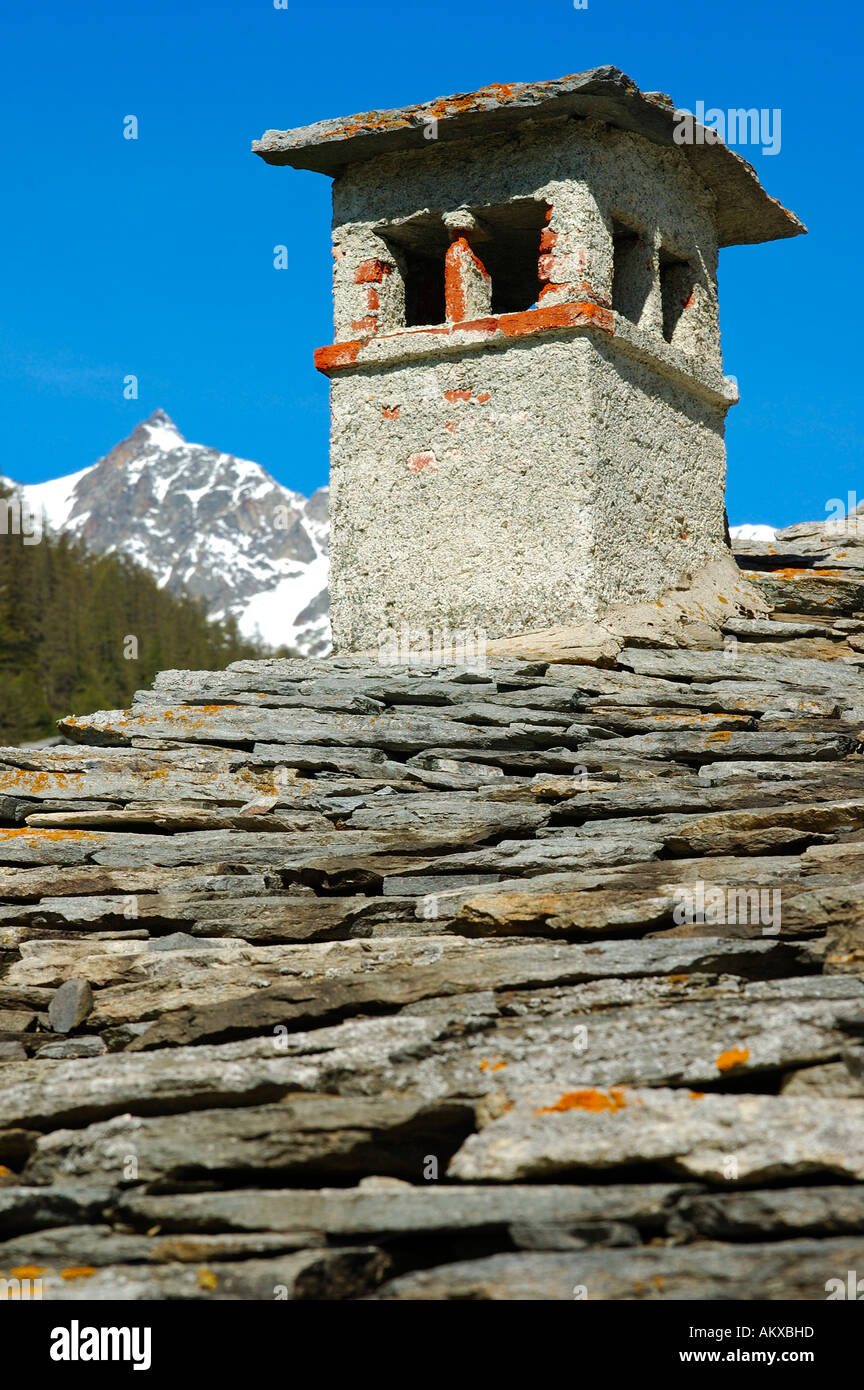 Smokestack of traditional stone houses, Simplon village, Valais, Switzerland Stock Photo