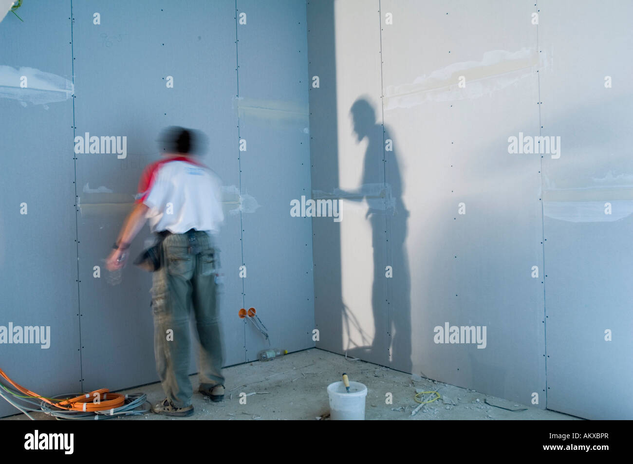 Construction worker inside an house shell Stock Photo