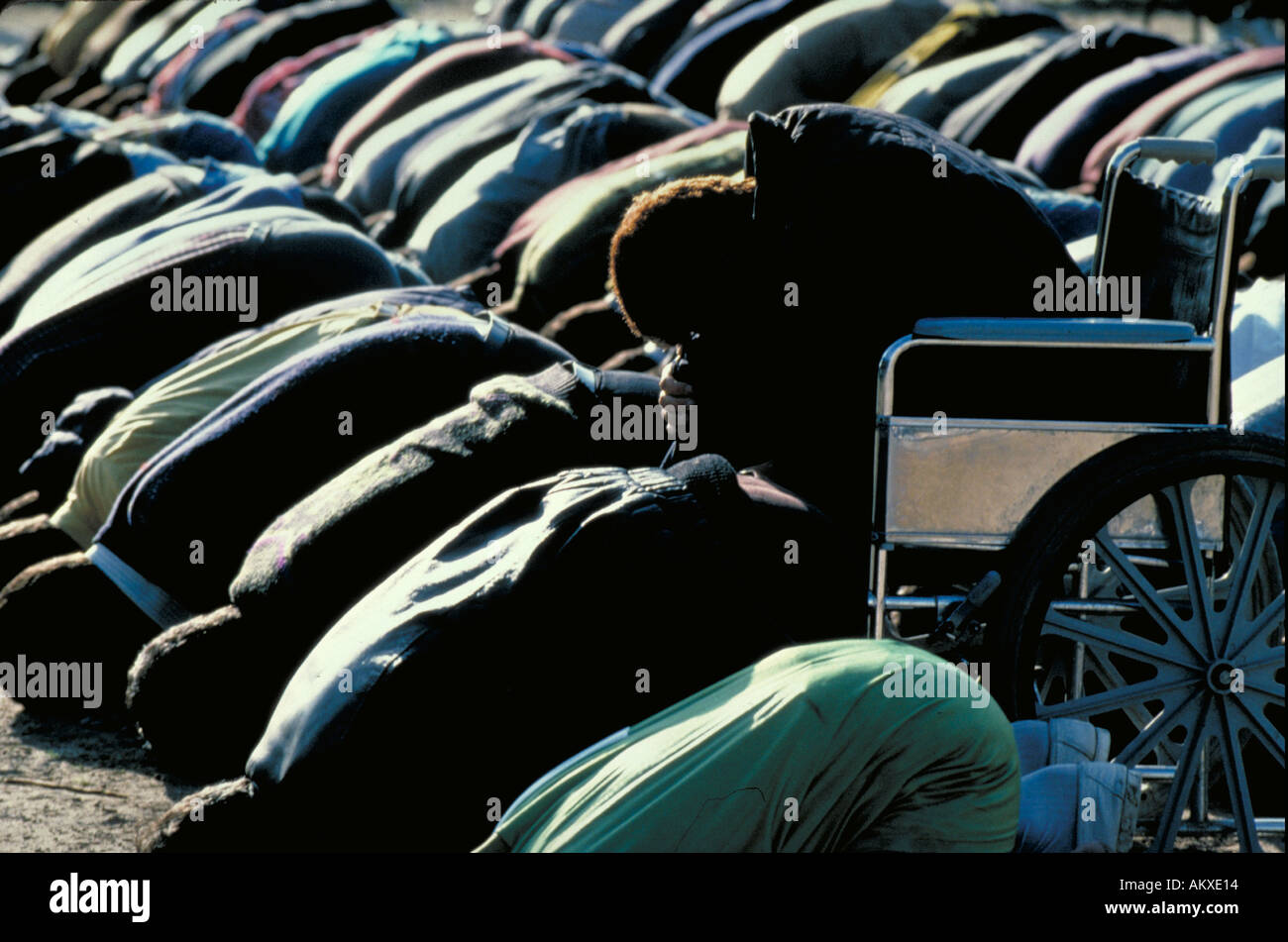PALESTINIANS PRAYING MAN IN WHEELCHAIR BOWS TO MECCA MOSLEM PRAYER Stock Photo