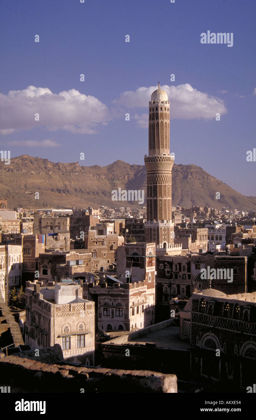 Tall domed minaret tower projecting high above Sana s rooftops Islam Sana Yemen Stock Photo