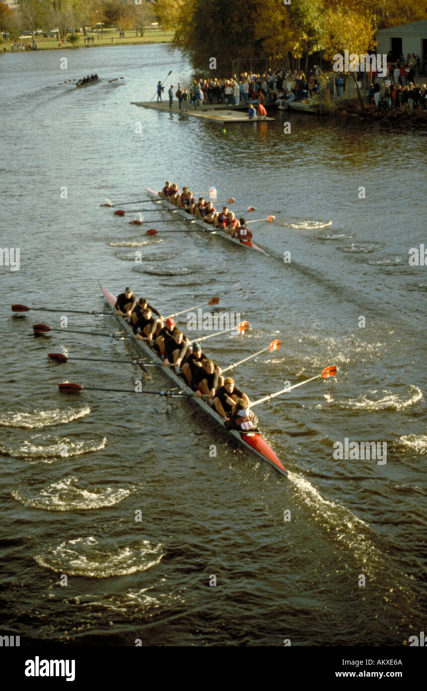 Three nine man crews race at the Head of the Charles Regatta boats