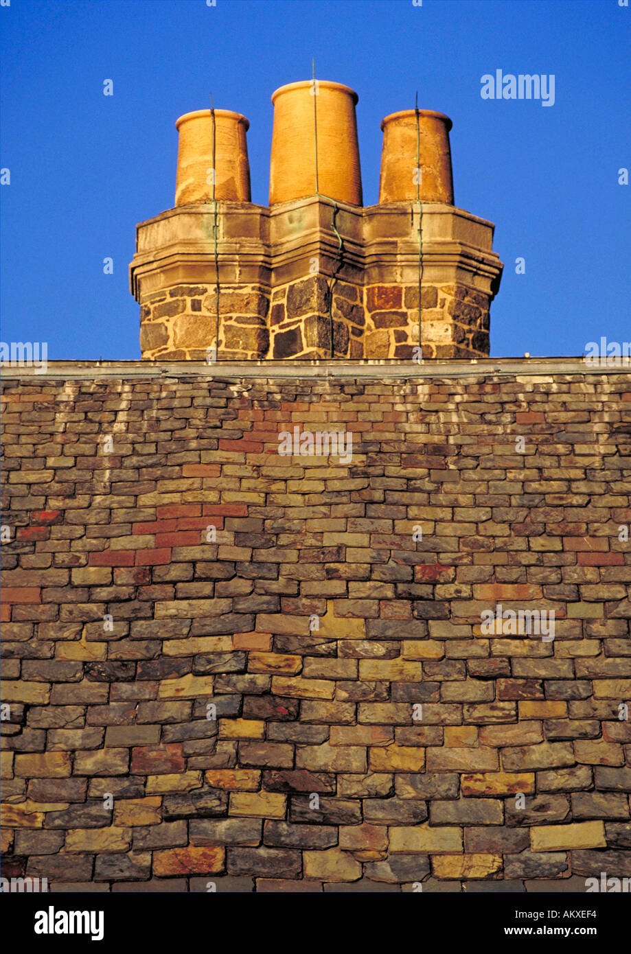 Slate rooftop with triple flute chimney Stock Photo