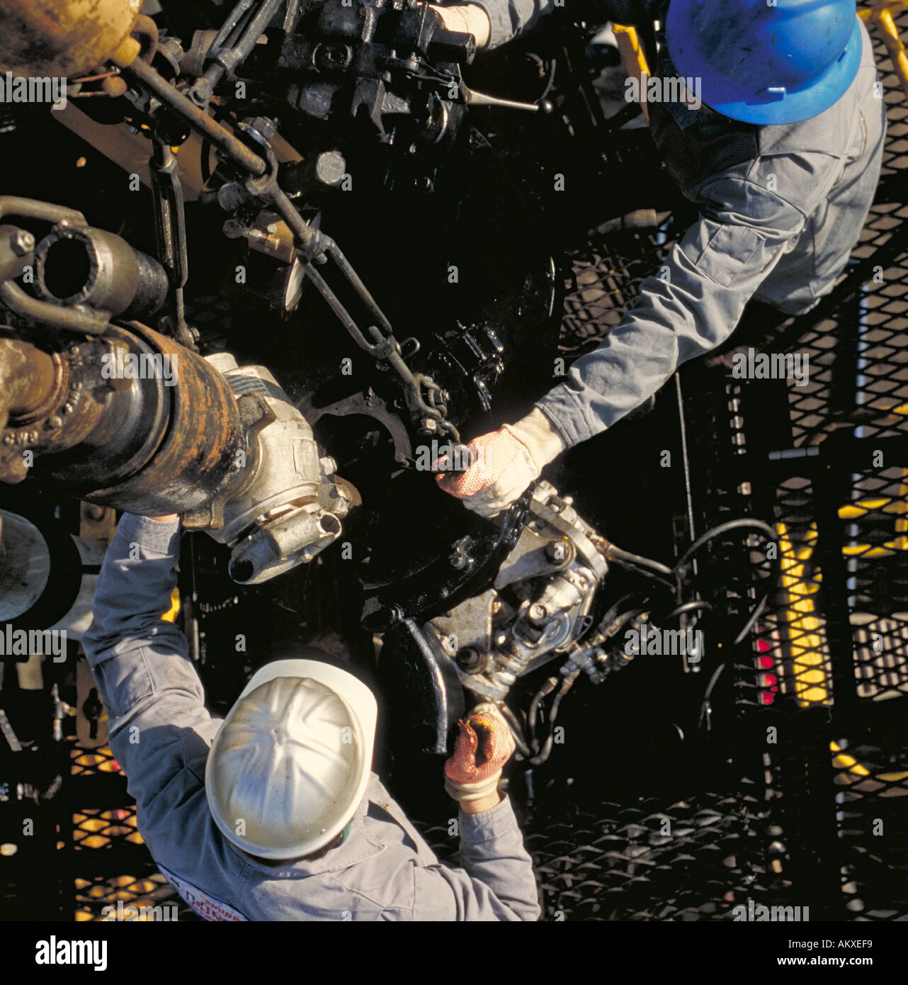 Overhead view of roughnecks on oil drilling platform Stock Photo