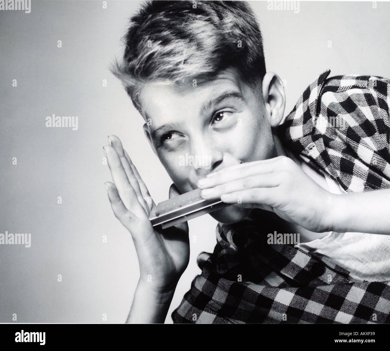 Young boy playing harmonica 1950 s Stock Photo 2813752 Alamy