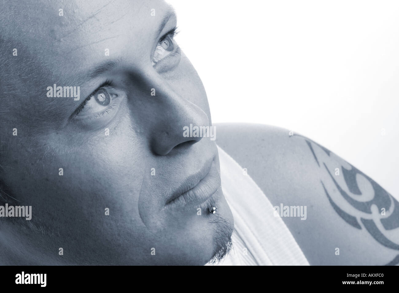 Thirties pierced guy thoughtful Stock Photo