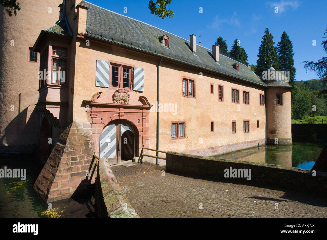 The moated castle Mespelbrunn is located in a remote side valley of the Elsava valley in Spessart, Bavaria, Germany. Stock Photo