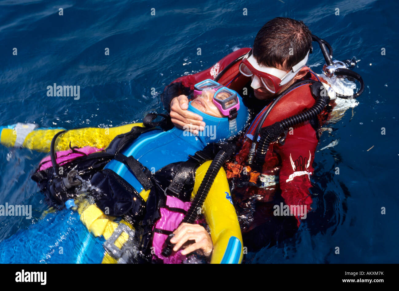 Rescue and emergency rise of an unsuccessful diver by a rescue diver. Stock Photo