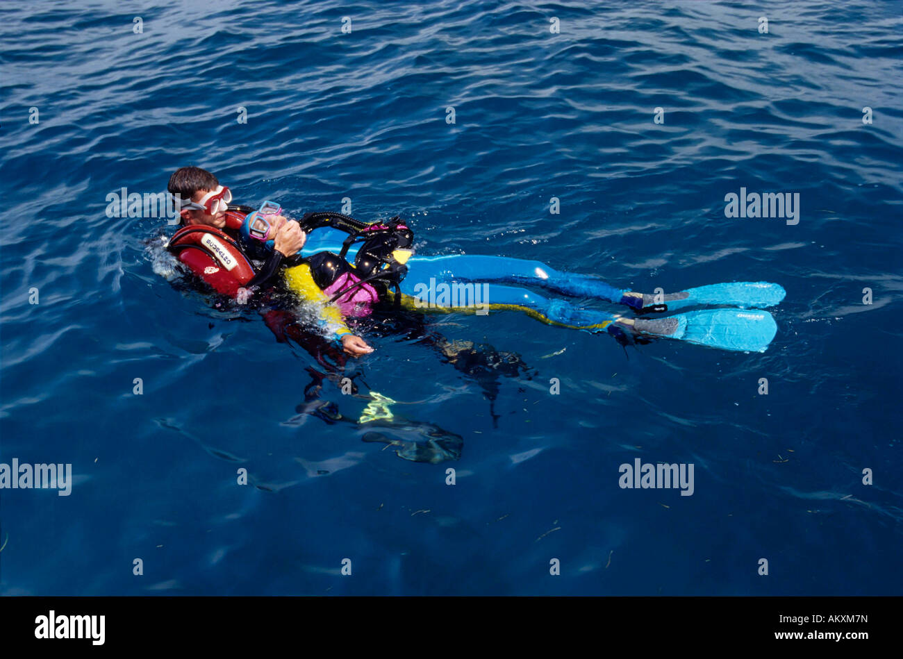 Rescue and emergency rise of an unsuccessful diver by a rescue diver. Stock Photo