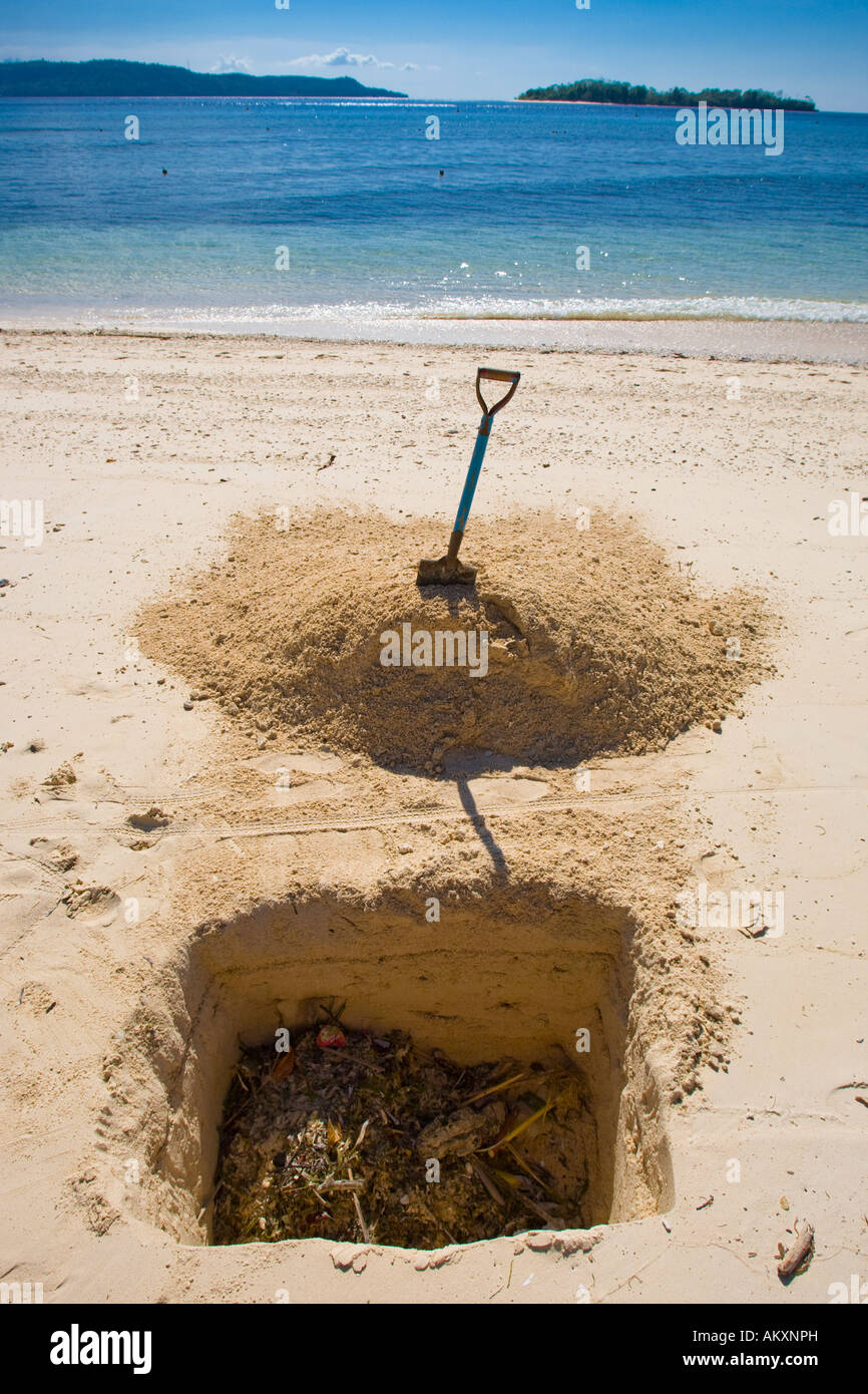 Garbage will bury in a pit on the beach. Indonesia. Stock Photo