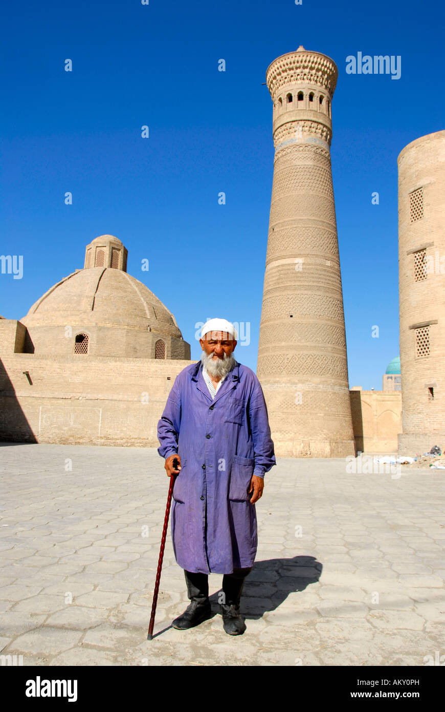 Old Muslim believer with beard in front of Minaret Kalon Bukhara Uzbekistan Stock Photo