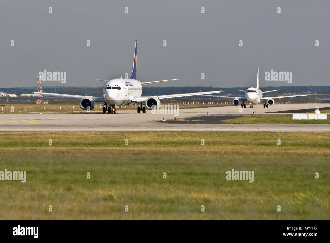 2 airplanes waiting for take off Startbahn 18 West, Airport Frankfurt, Hesse, Germany Stock Photo
