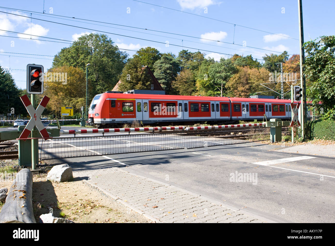 St Andrew´s Cross with red traffic light and closed gates, train driving past, Hessen, Germany Stock Photo