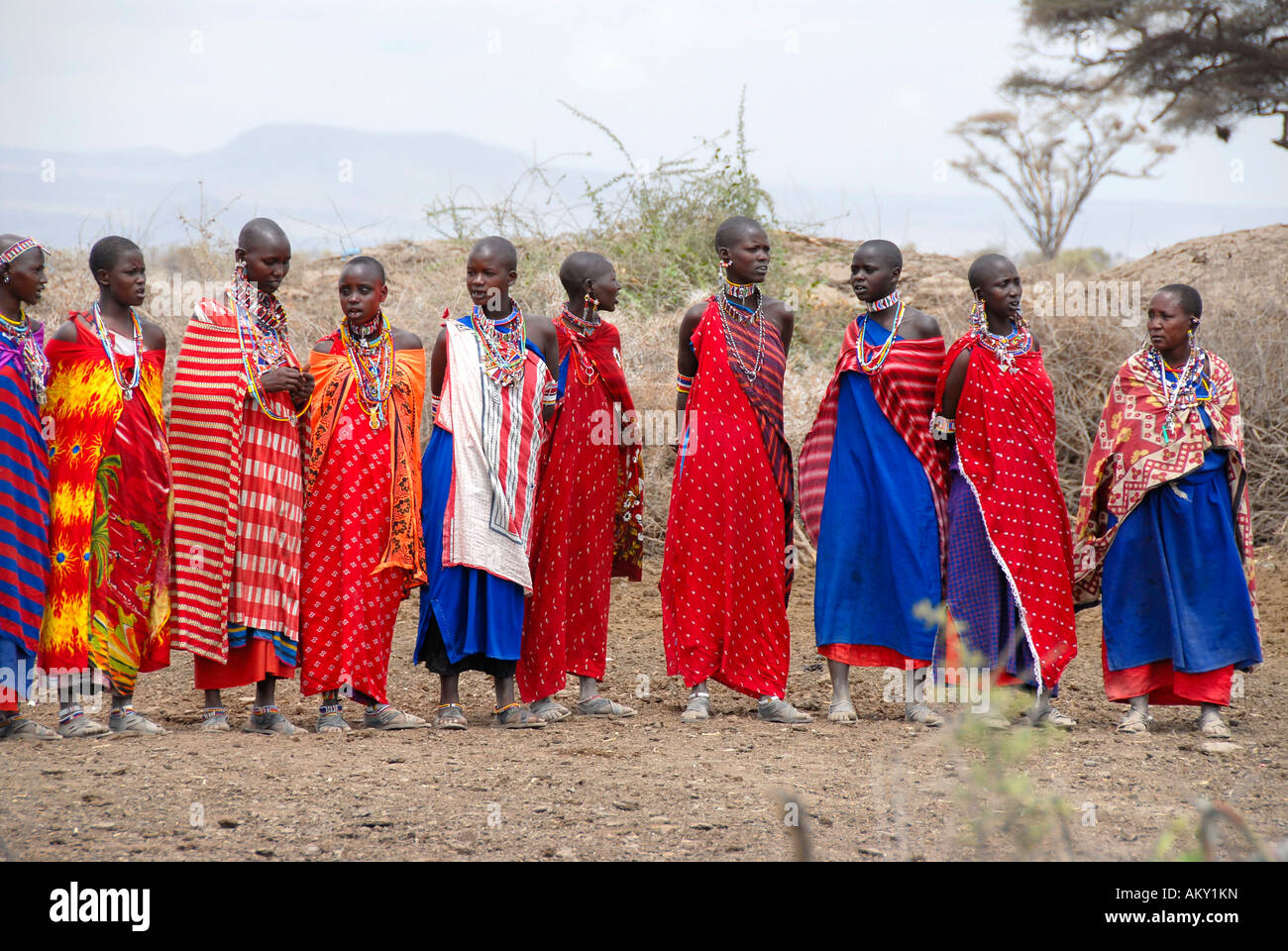 Masai woman dressed in colourful capes stand side by side Amboseli National Park Kenya Stock Photo