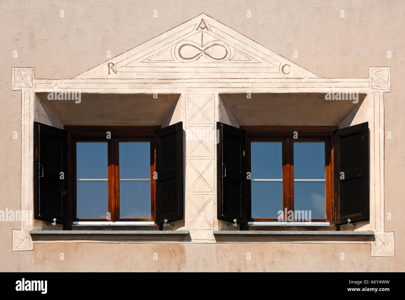 Window view of an Engadine house decorated with Sgraffito ornaments, Samedan, Engadin, Grisons, Switzerland Stock Photo