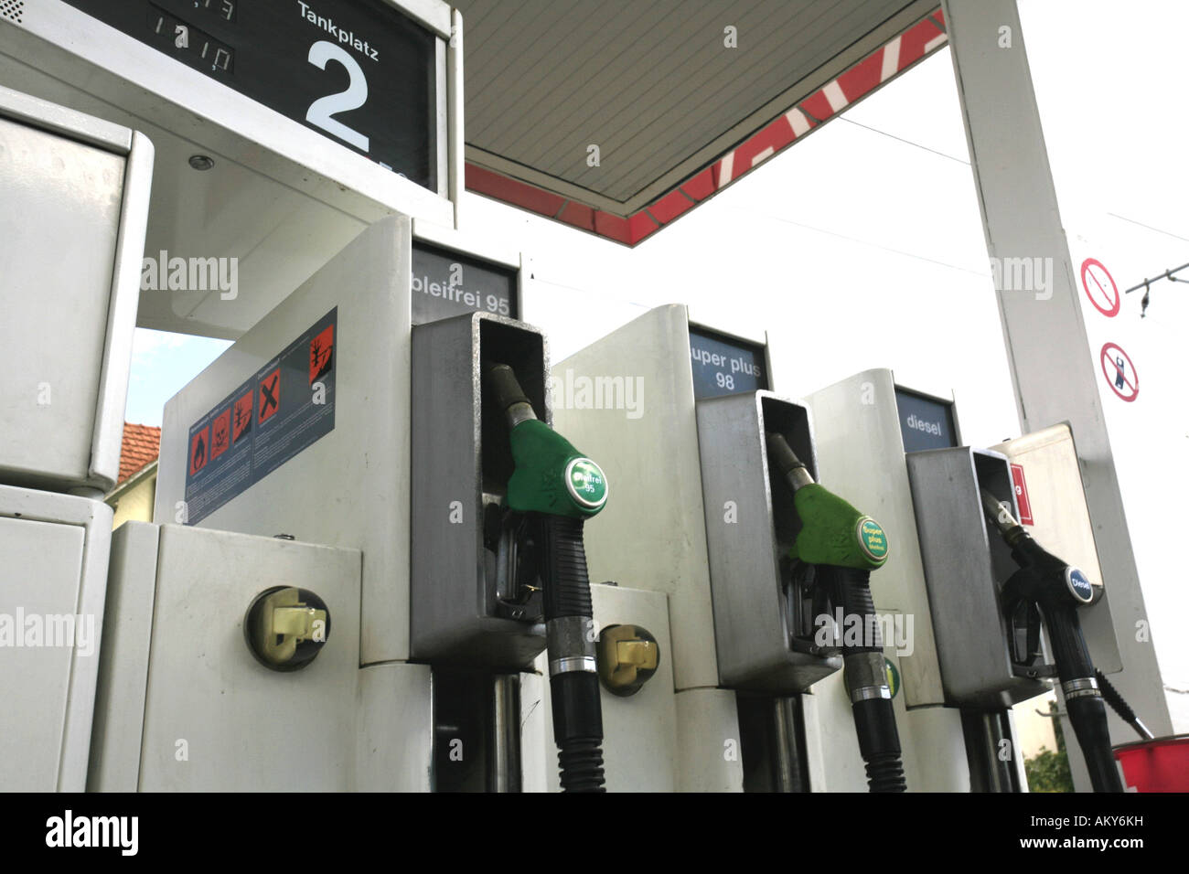 Fuel nozzles at a gas station Stock Photo Alamy