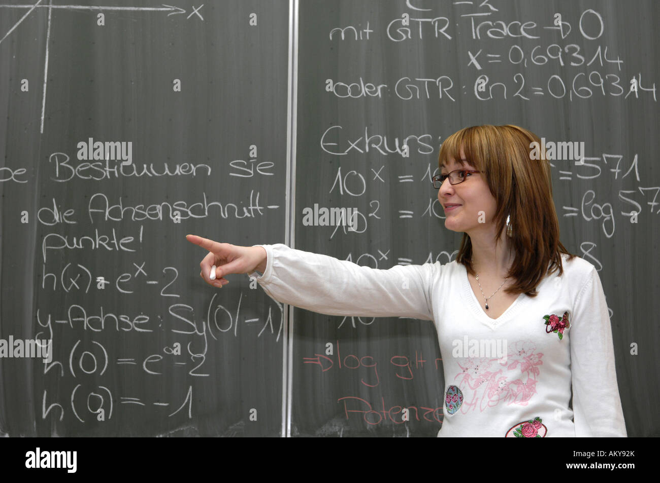 Young female teacher teaching maths Stock Photo