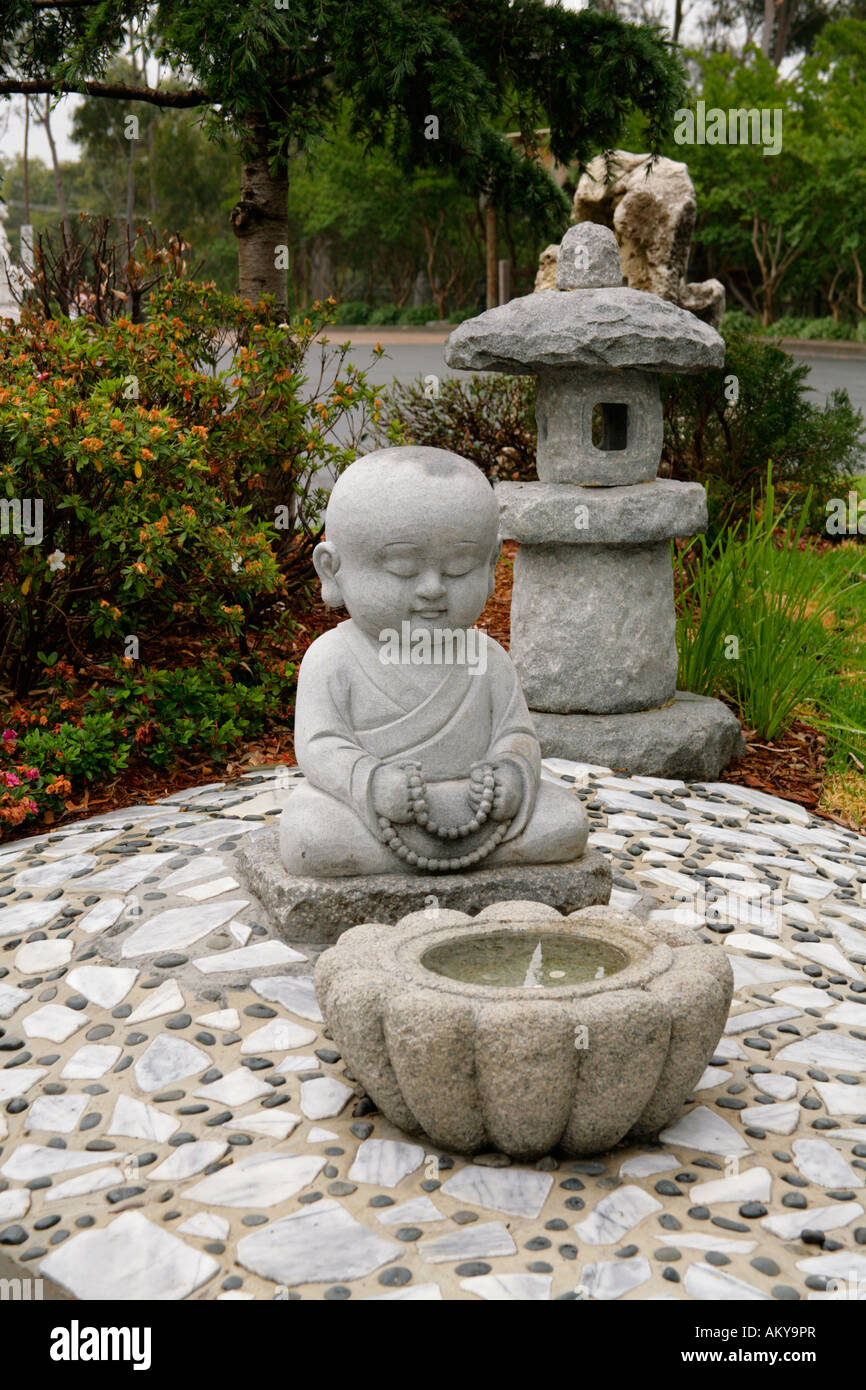 Baby Buddha statue with offering bowl,Nan Tien Buddhist Temple grounds,Berkeley,New South Wales. Stock Photo