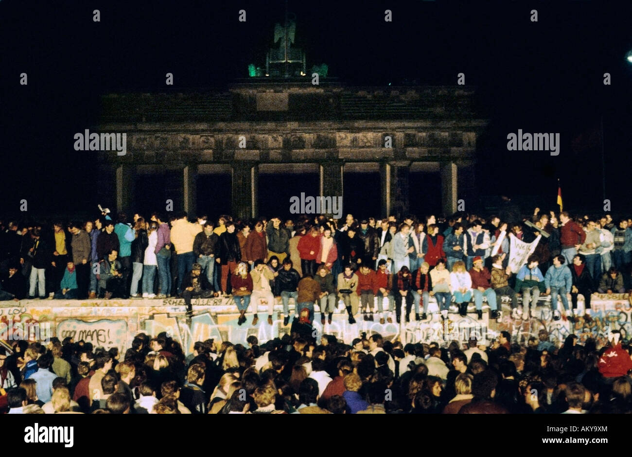 Fall of the Berlin Wall: people from East and West Berlin climbing on the Wall at the Brandenburg Gate on 9th November 1989, Be Stock Photo