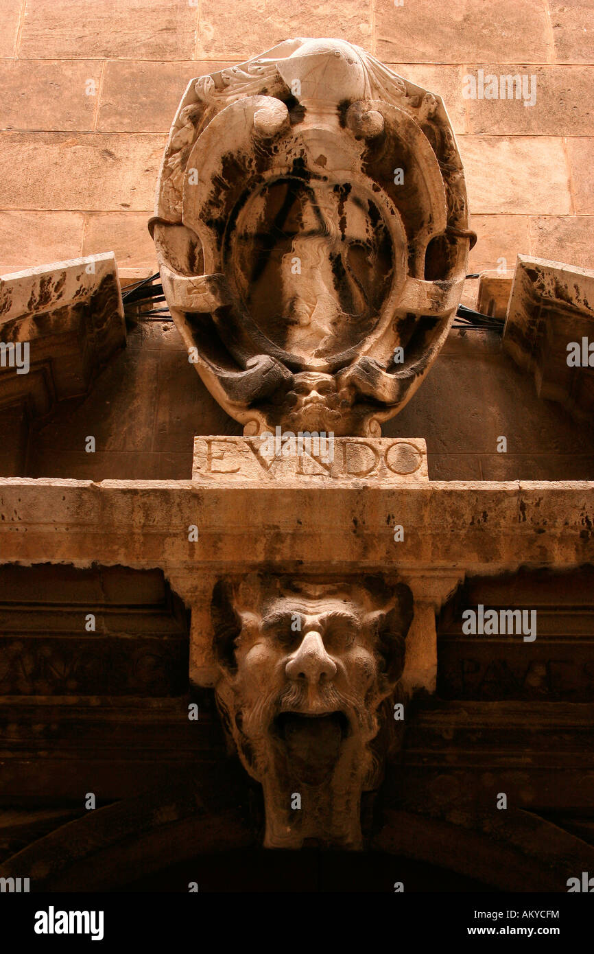 Coat of arms and face on a facade in the old town of Palma de Mallorca, Majorca, Spain, Europe Stock Photo