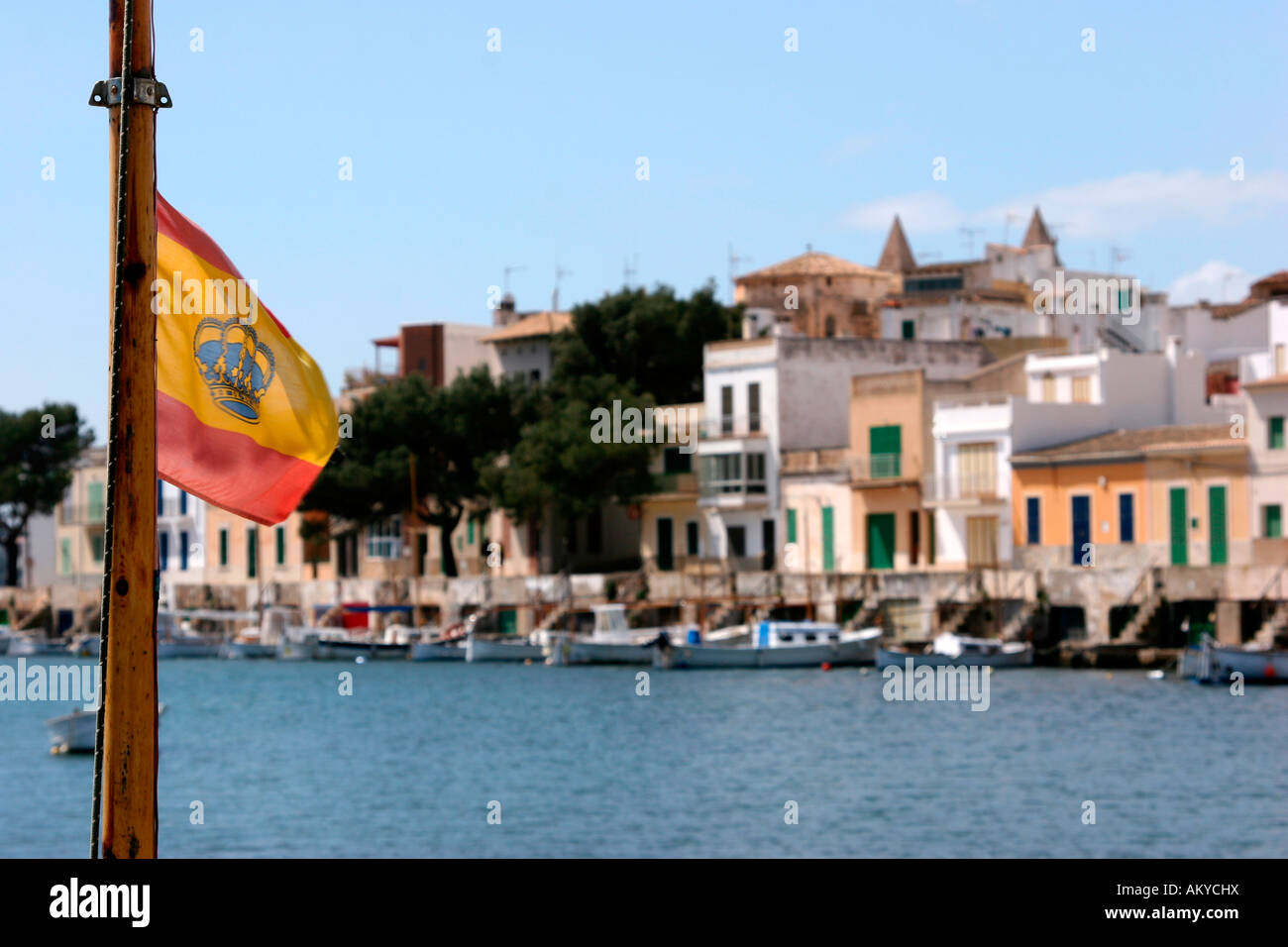Spanish flag with crown in the harbour of Porto Colom, Majorca, Spain, Europe Stock Photo