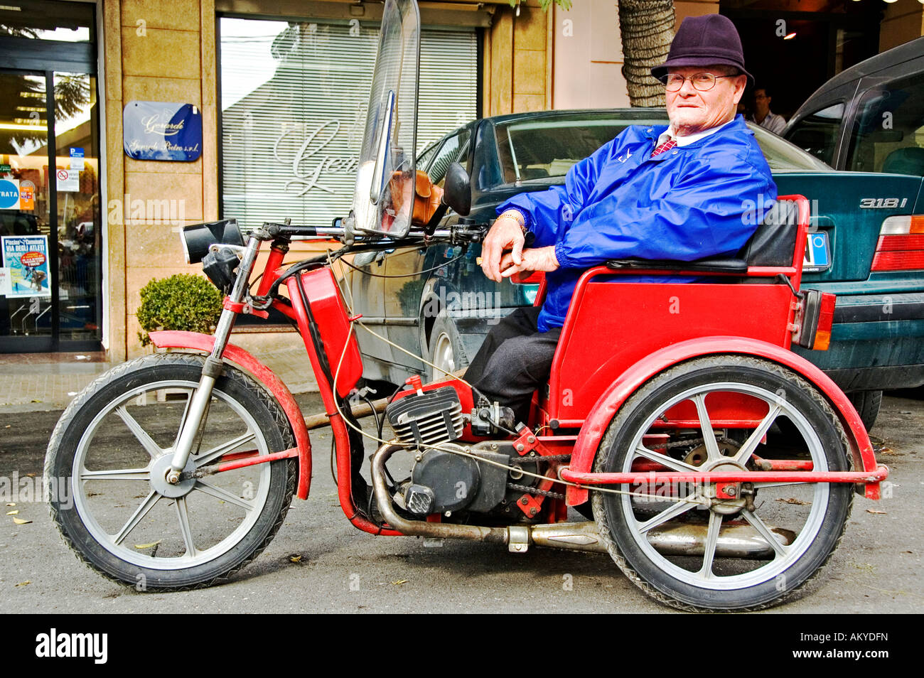 Handycapped senior in his motorised weelchair, Marsala, Sicily, Italy Stock Photo