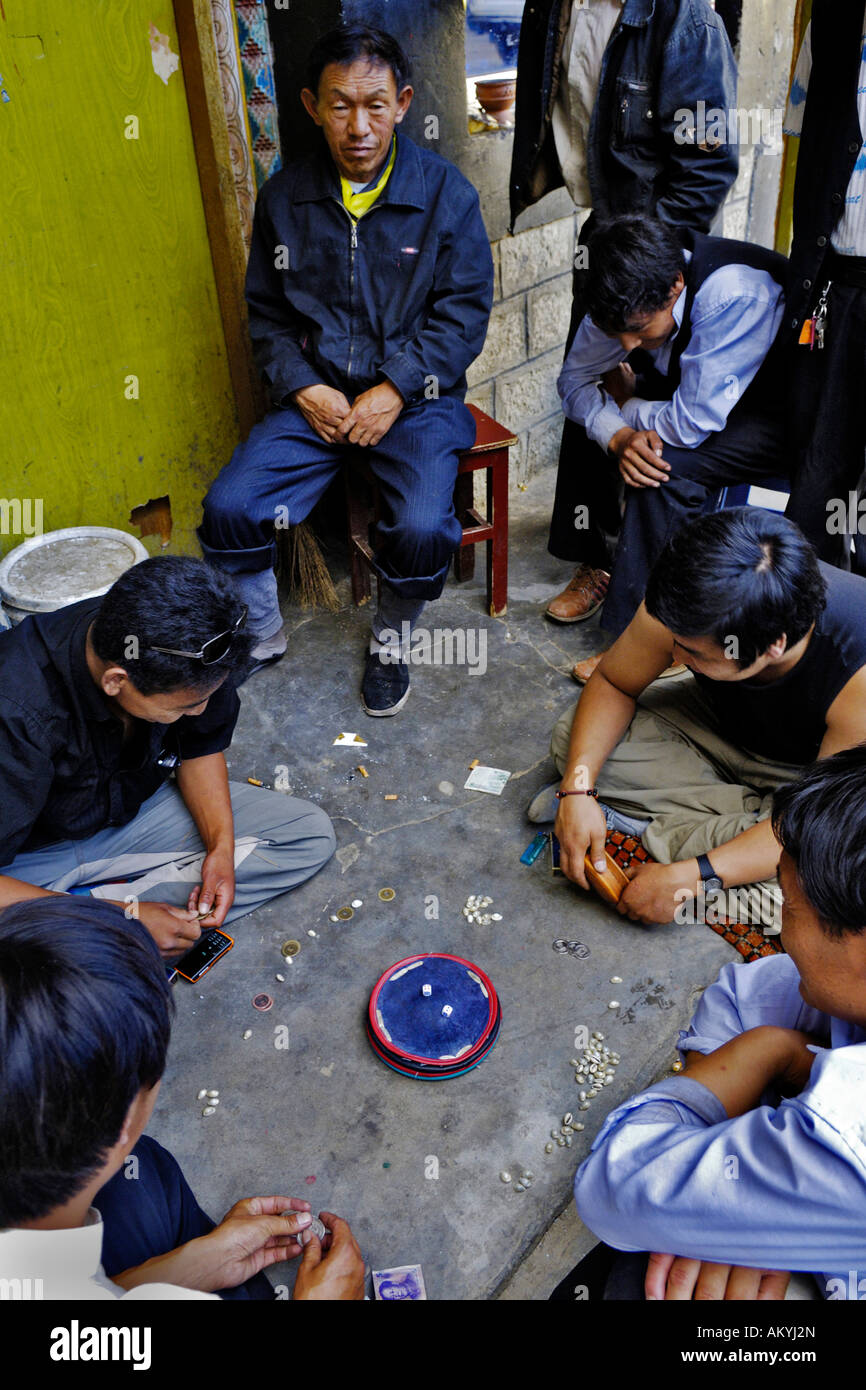 Tibetan men play dice game, Samye, Tibet Stock Photo