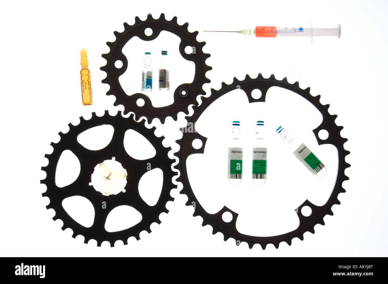 Gear wheels and medicines symbolize medicine abuse (doping) in the cycling. Stock Photo
