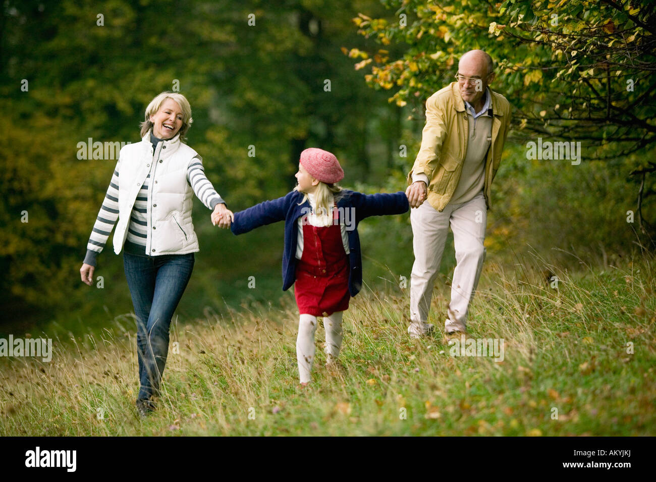 Germany, Baden-Württemberg, Swabby woodian mountains, Grandparents and granddoughter (6-7) walking in forest Stock Photo