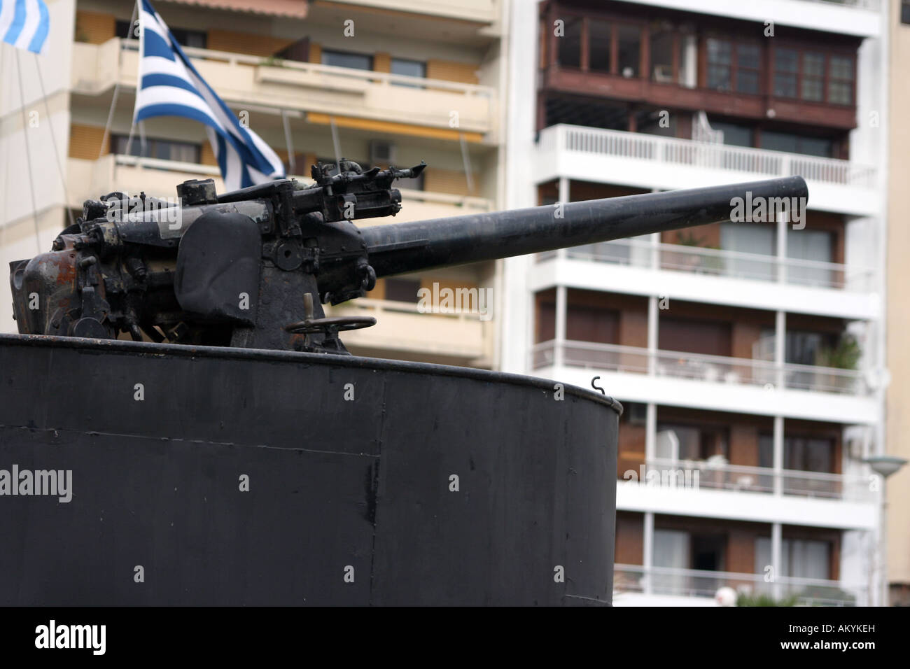 antique fire gun from old navy submarine with houses blur in background at piraeus athens greece Stock Photo