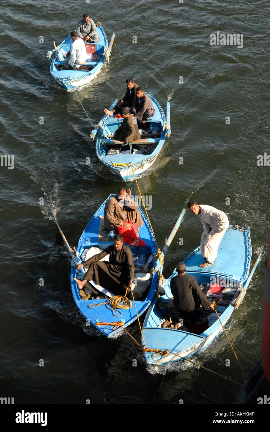Traders on small ships at cruise ships that have to wait at the lock of Esna, Egyt Stock Photo