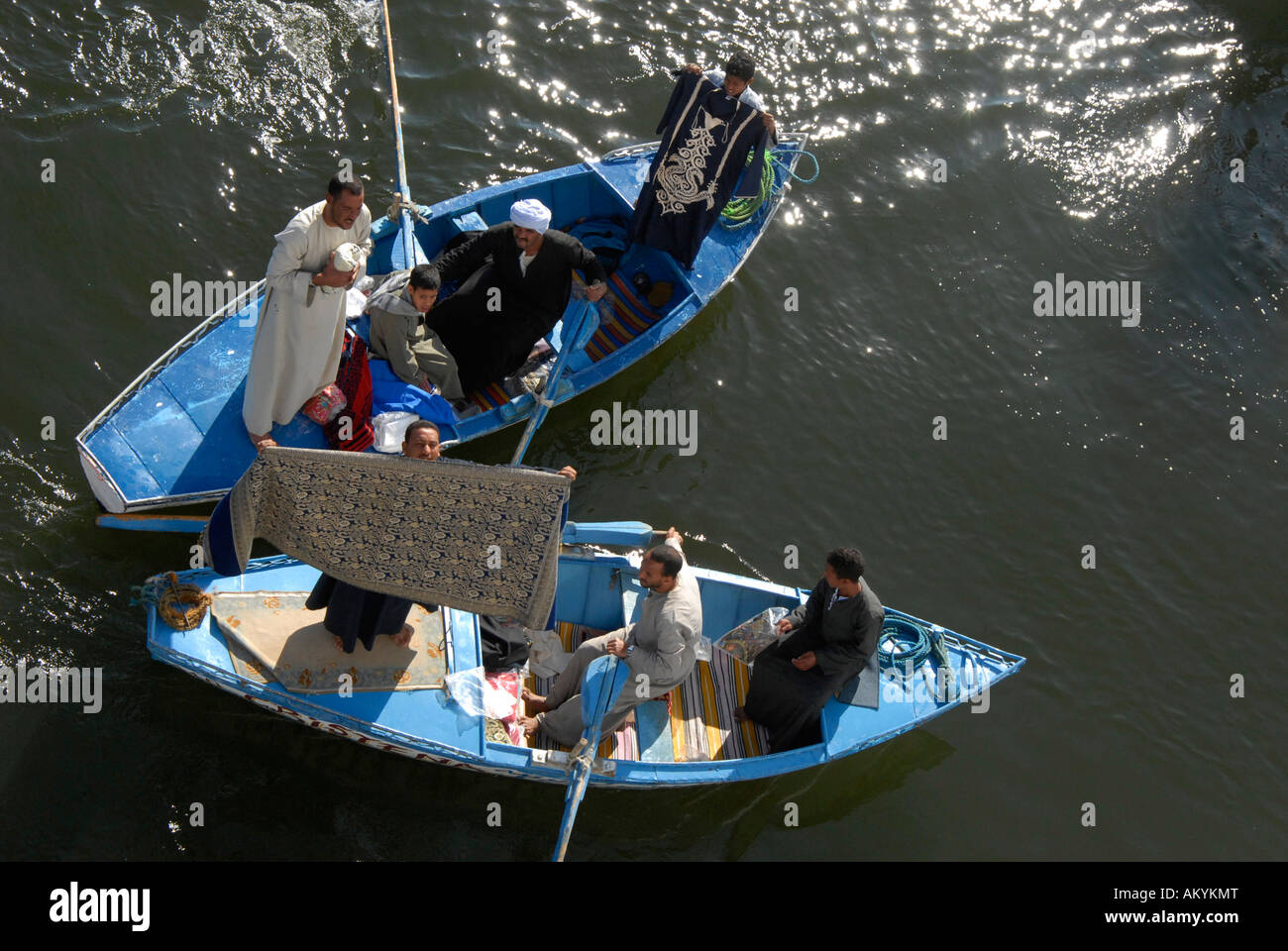Traders on small ships at cruise ships that have to wait at the lock of Esna, Egyt Stock Photo