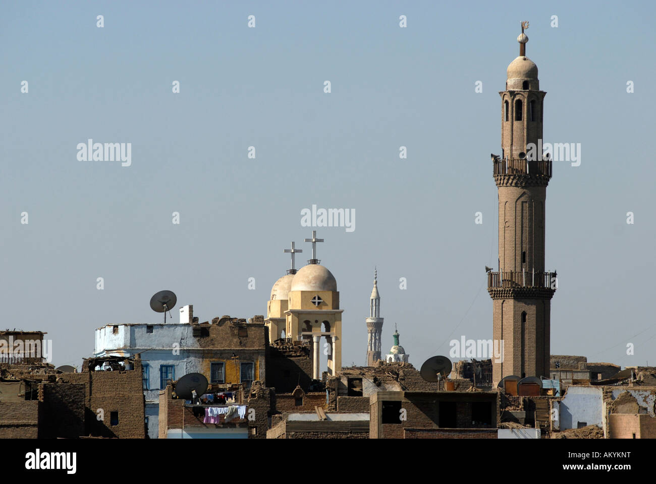 Signs of different religions. Left a christian copt church, right an mosque, Esna, Egyt Stock Photo