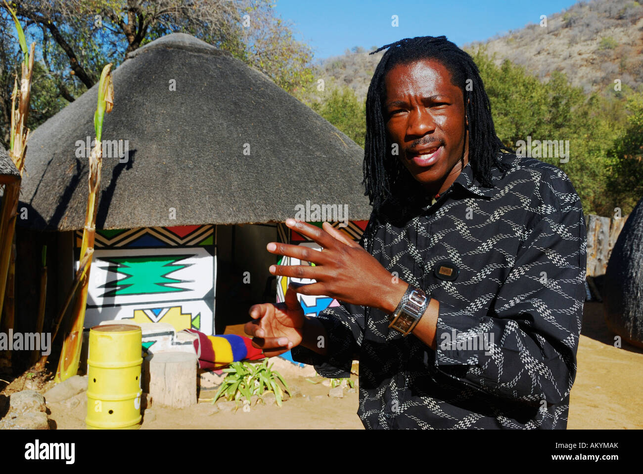 Tourist guide explains the the life in a Ndebele hut South Africa, Africa Stock Photo