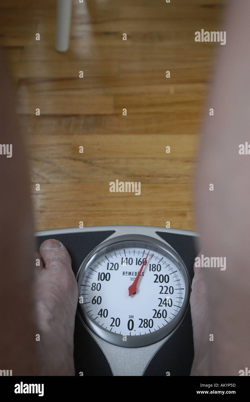 man male weigh weighing scales scales slim obese overweight light heavy