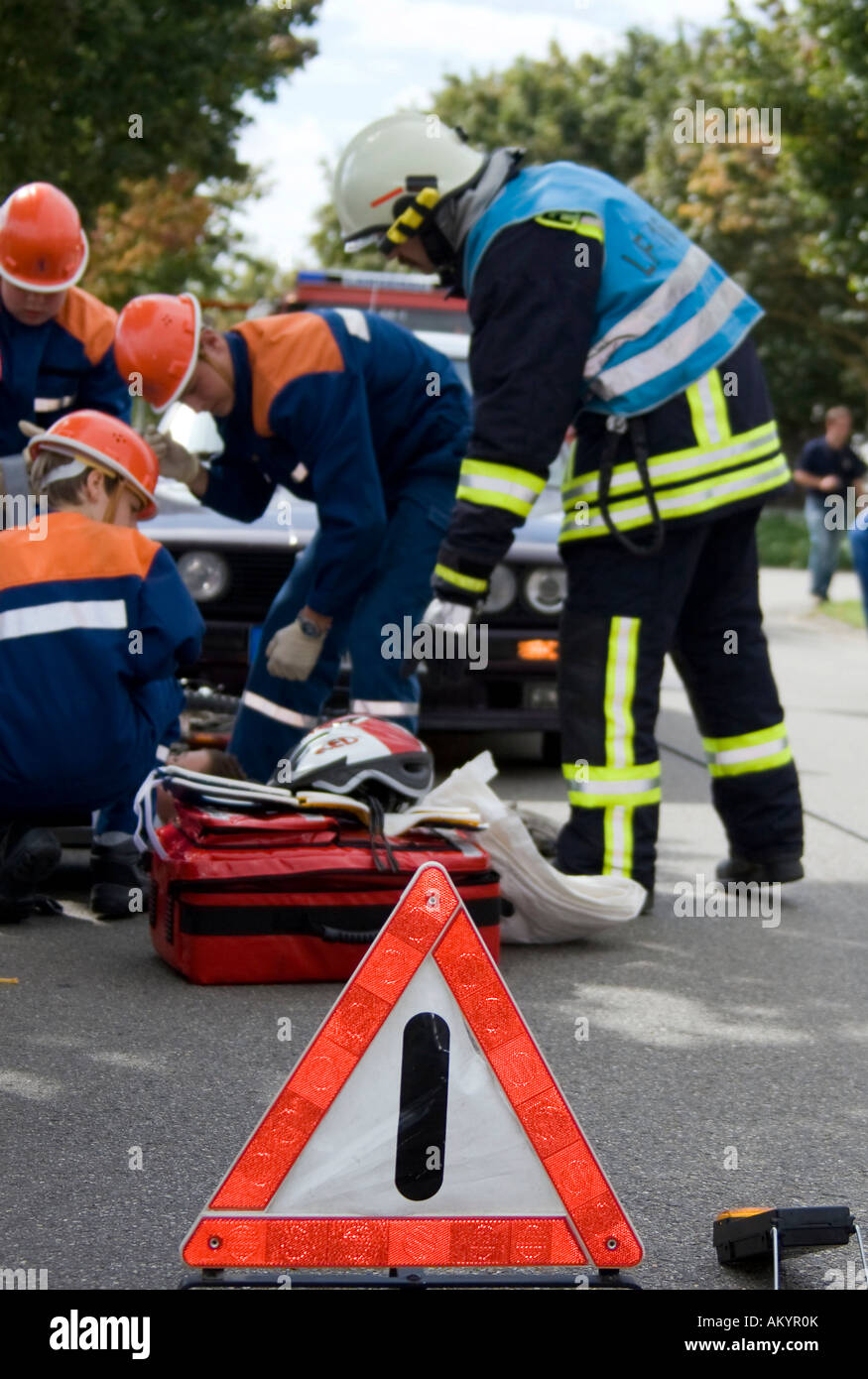 A youth fire brigade shows what to do at an scene of an accident Stock Photo