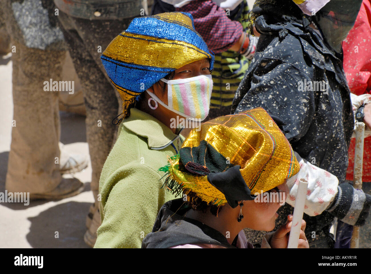 Young girls compressing new ground with their feet, Potala, Lhasa, Tibet Stock Photo