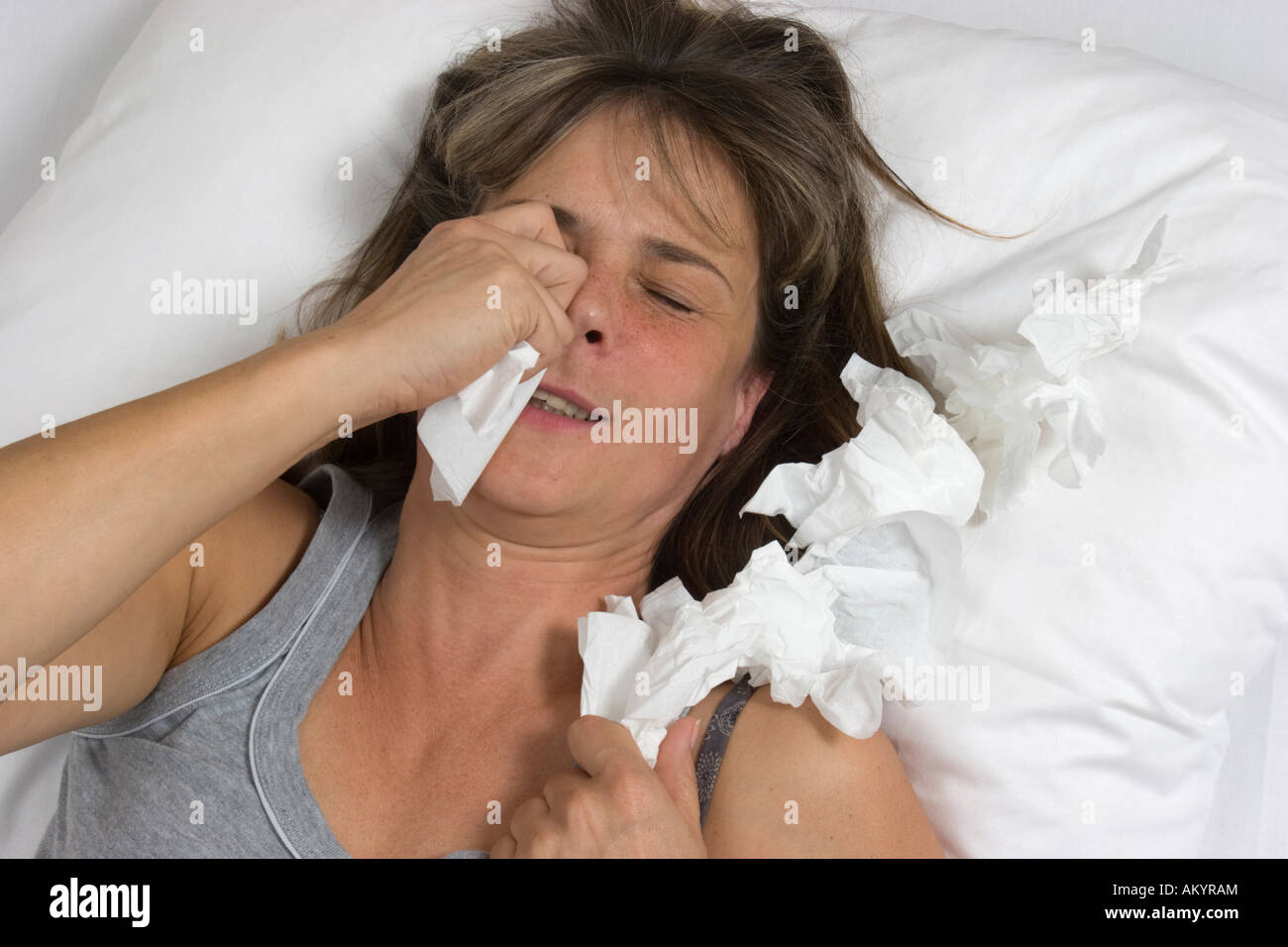 Crying woman in bed Stock Photo