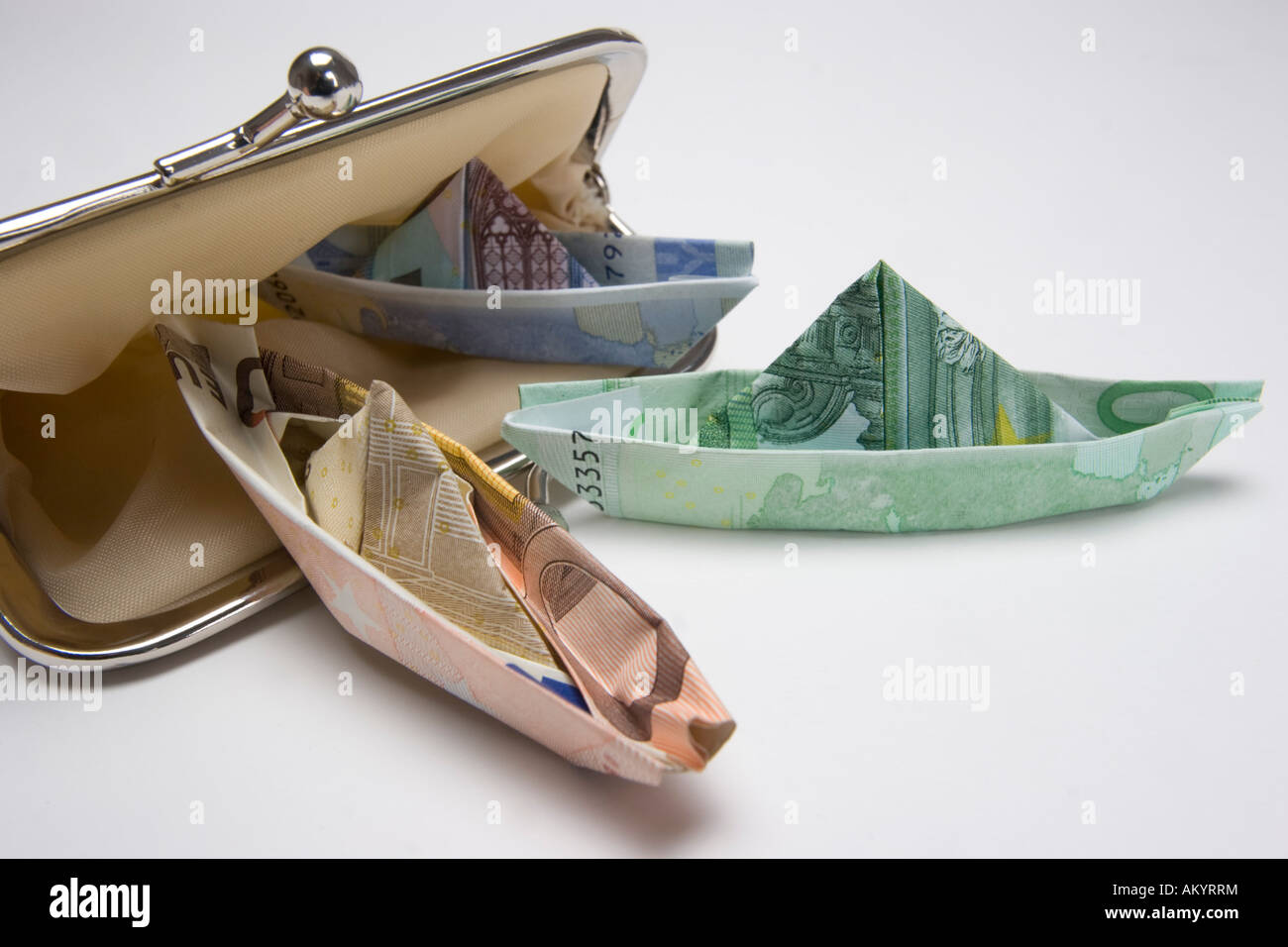 Small ships made of banknotes in a purse Stock Photo