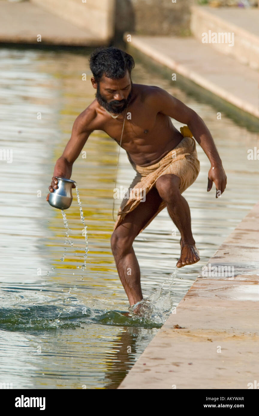 A Hindu pilgrim bathes in the sacred waters of Pushkar Lake at Gangour Ghat, Pushkar, Rajasthan, India. - Stock Image