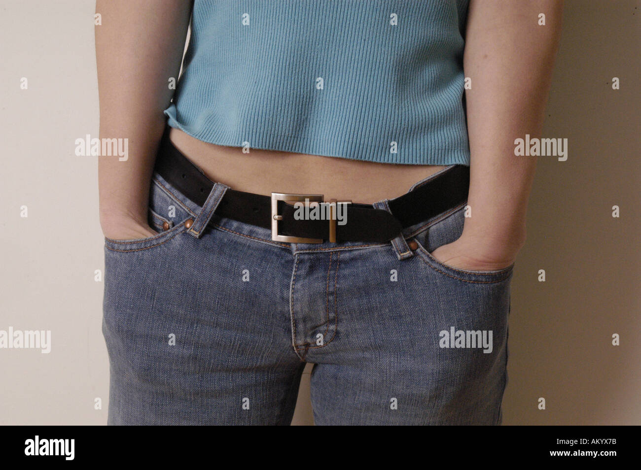 https://c8.alamy.com/comp/AKYX7B/waist-jeans-woman-female-girl-belt-buckle-belly-tummy-stomach-ache-AKYX7B.jpg