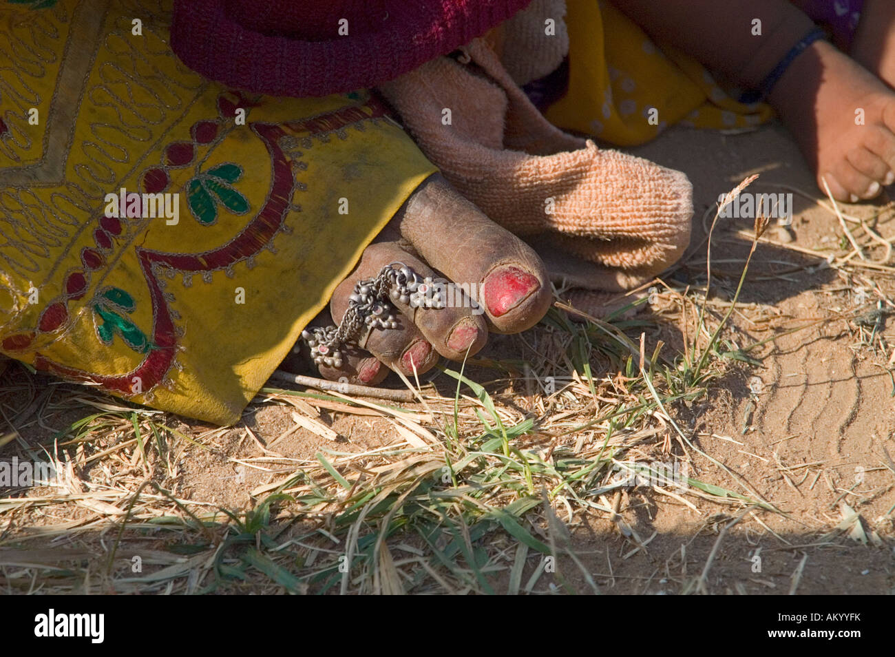 The tough but bejeweled foot of a Rajasthani farm woman in the village of Nimaj, Rajasthan, India. - Stock Image