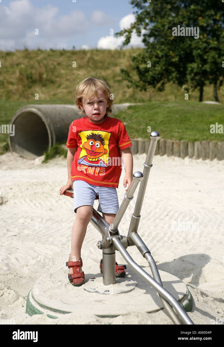 Three-year-old boy on a toy excavator Stock Photo